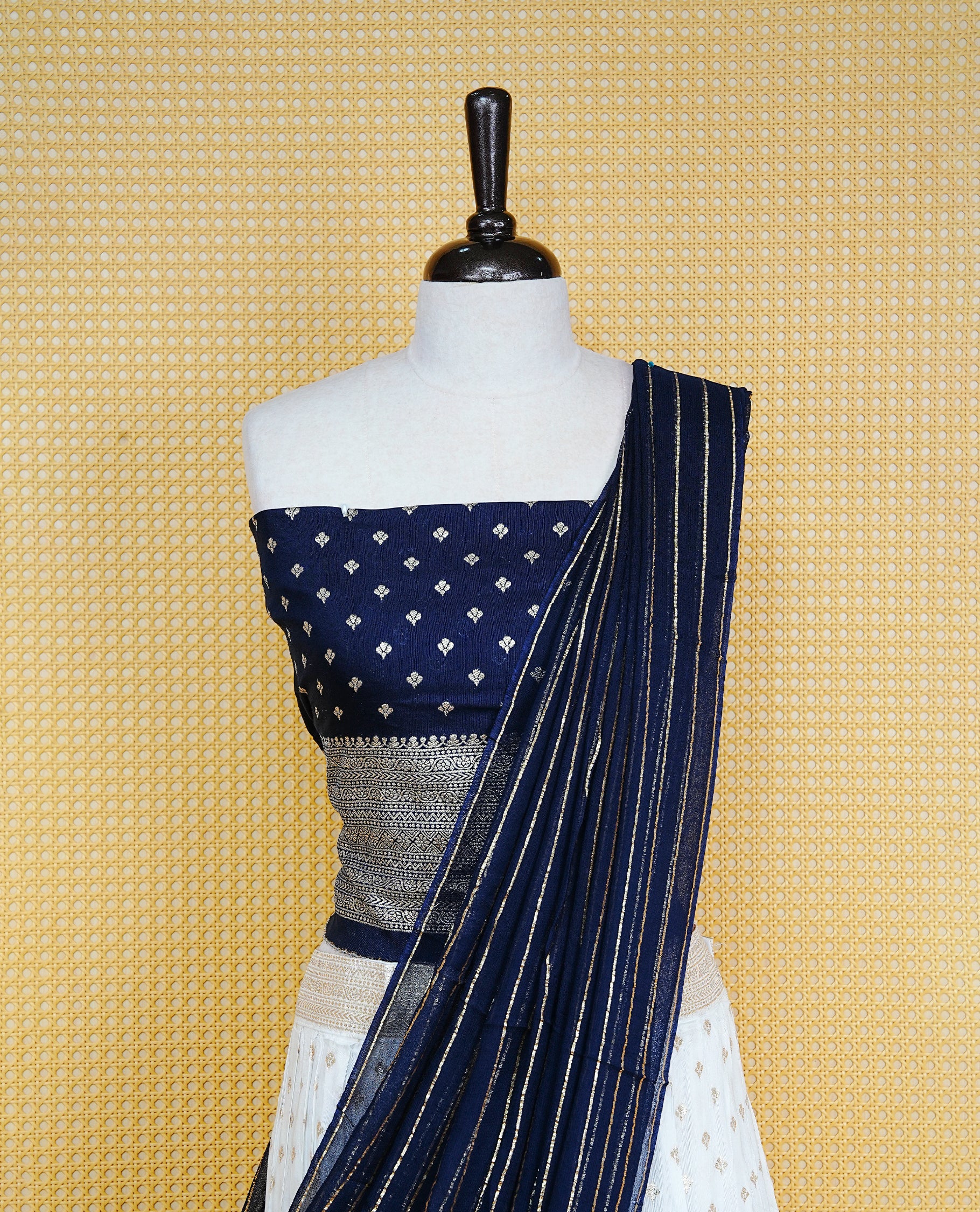 Cream colour Semi Stitched Dhavani Set Cream colour Skirt With Floral Motifs on Border, Paired with Contrast Navy Blue colour With Gold zari motifs on Unstitched Blouse, Elegant Dupatta For Prefect look.