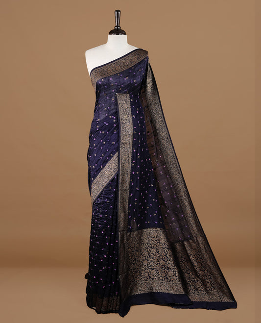 Dark purple colour Banarasi Bandhani silk saree featuring intricate antique zari circle Buttas across the body, complemented by an elegant antique zari border. Comes paired with a matching blouse piece