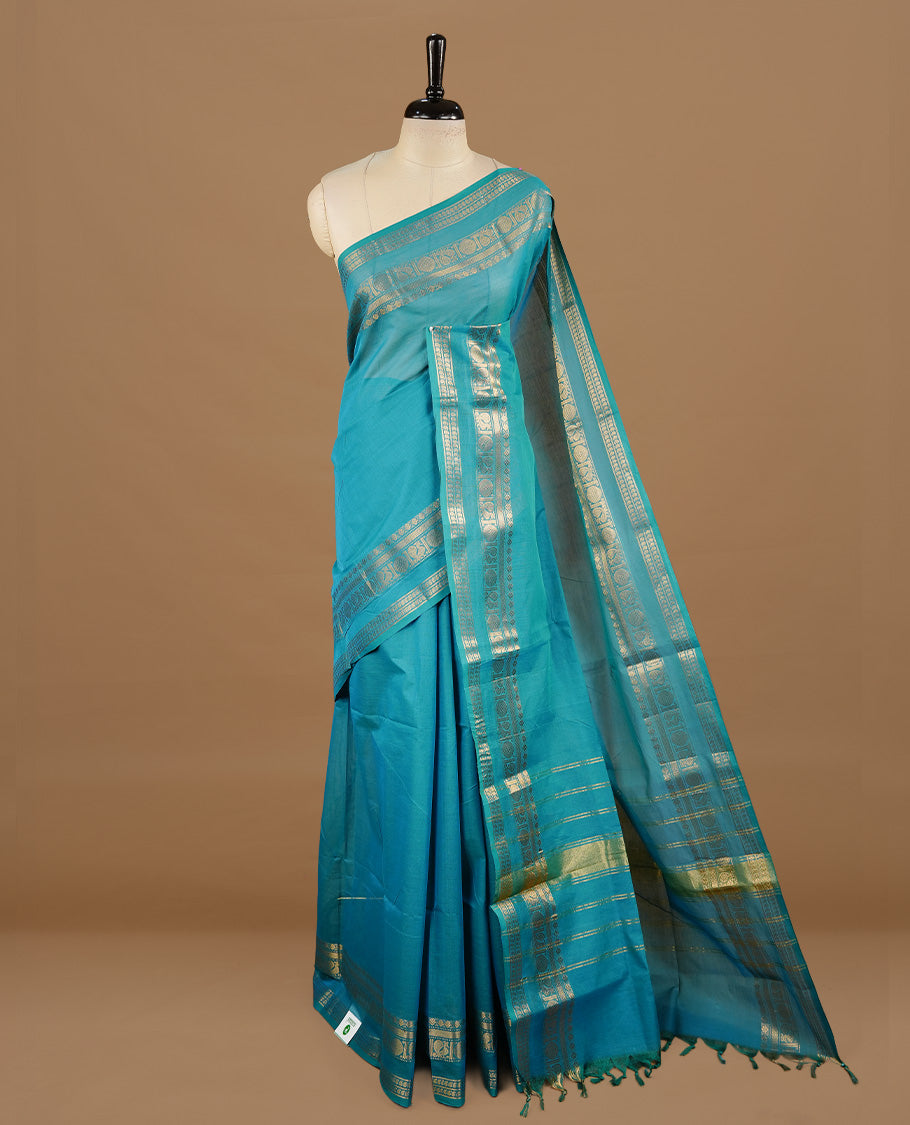 Aqua colour chettinad cotton saree featuring elegant plain body, complemented by self colour with zari border, paired with matching blouse piece.