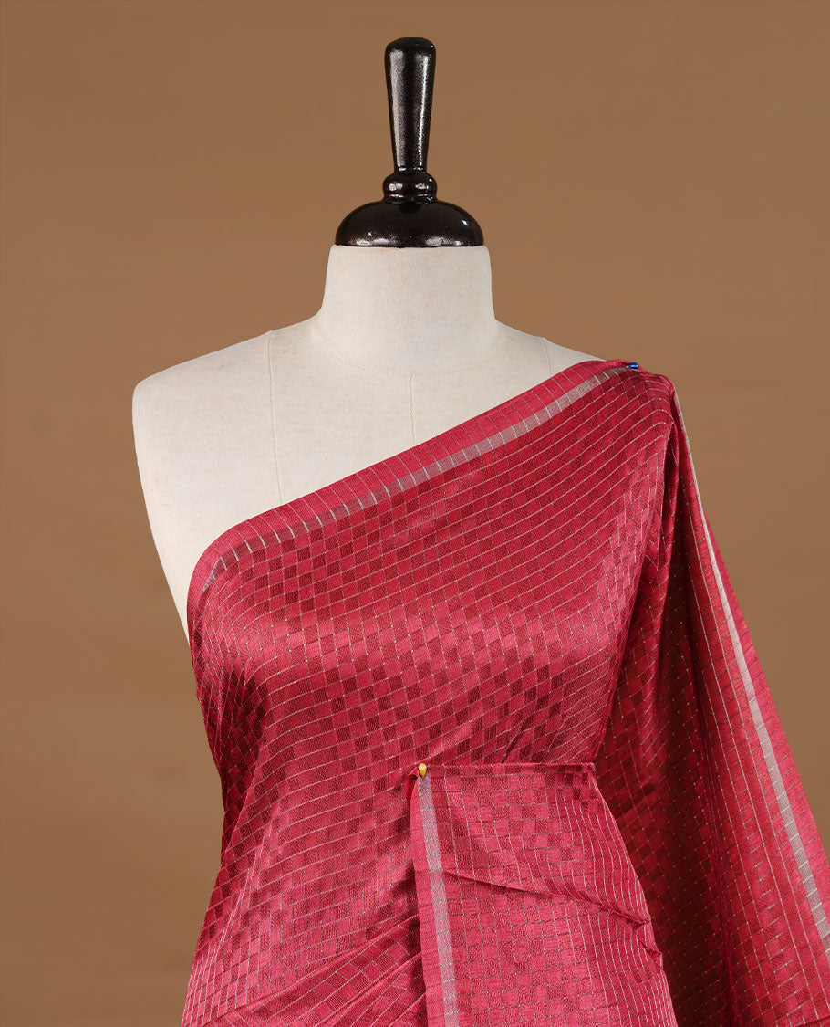 Rose Red colour Semi Tussar saree featuring an elegant zari fancy check pattern on the body, highlighted with a small border for a refined look. Comes without a blouse piece.