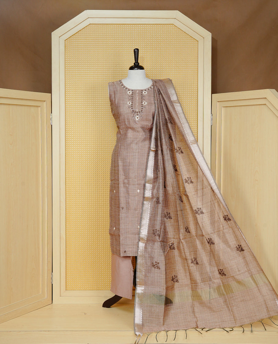 Brown colour Tissue Churidar Set featuring delicate floral embroidery and subtle sequin detailing on the yoke, paired with matching solid pants and dupatta.