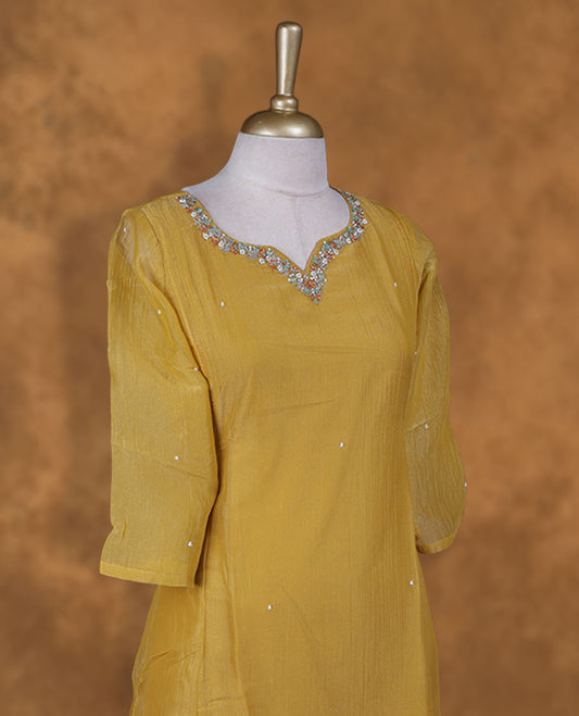 Mustard colour kurti  styled with agold colour thread & beats floral thread pattern Round neckline, knee length design, styled with a Round neckline and a  sleeve .
