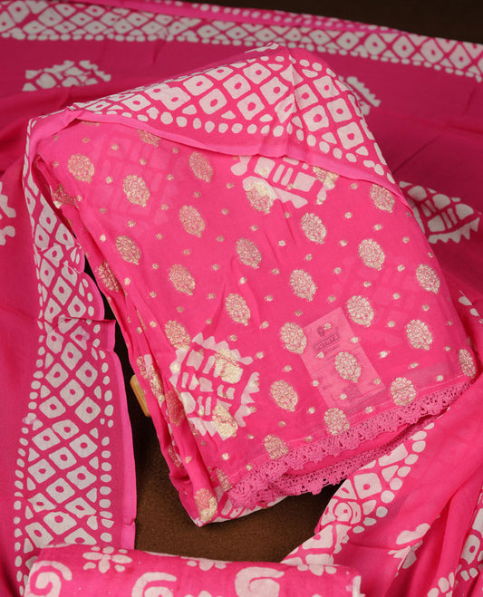 Pink colour churidar material featuring elegant gold butta work on the front panel, paired with a printed dupatta and matching bottom.