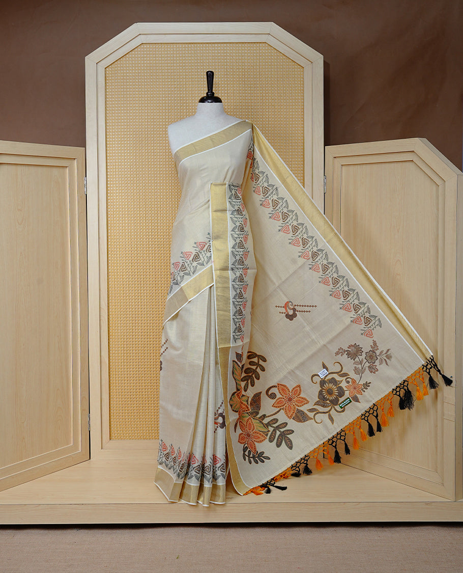 Cream Colour Tissue Kerala  Saree Featuring A Digital Floral Printed Body, Highlighted With Classy Gold Zari Border Black & Yellow Tassel At Pallu, Paired With A Matching Blouse Piece.
