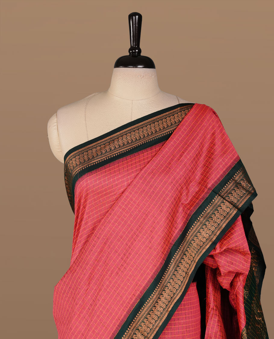 Magenta colour kalyani cotton saree featuring antique zari check pattern on body, complemented by green colour with Antique zari border, paired with matching blouse piece.