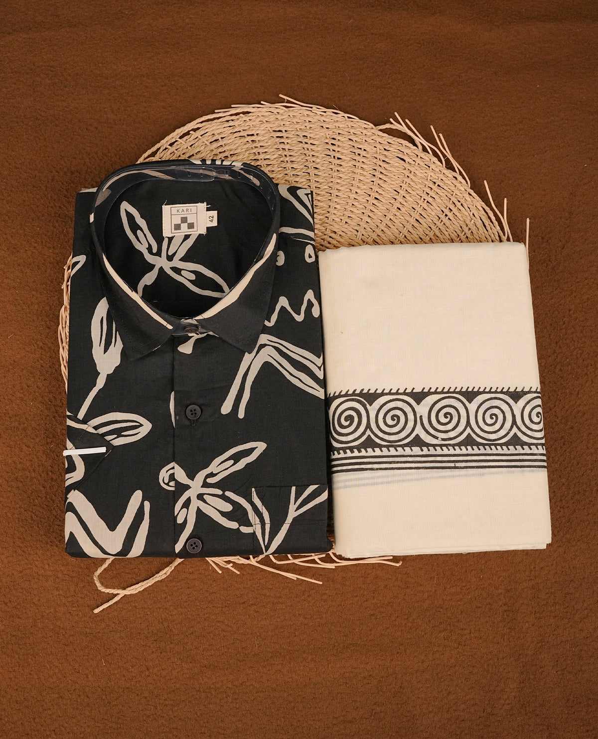 Black colour colour shirt featuring cream Floral Pattern printed body, paired with cream colour double dhoti featuring Black printed border.
