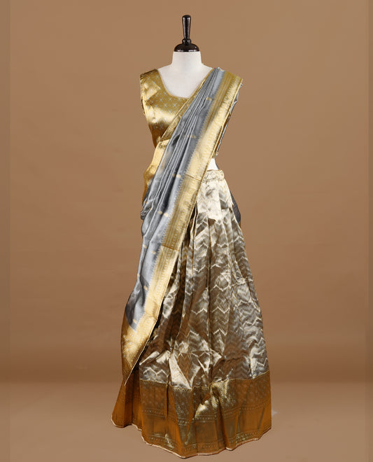 Antique gold colour semi stitched Half saree featuring contrast gold colour with traditional zari border skirt, paired with matching zari border dupatta,stitched blouse piece