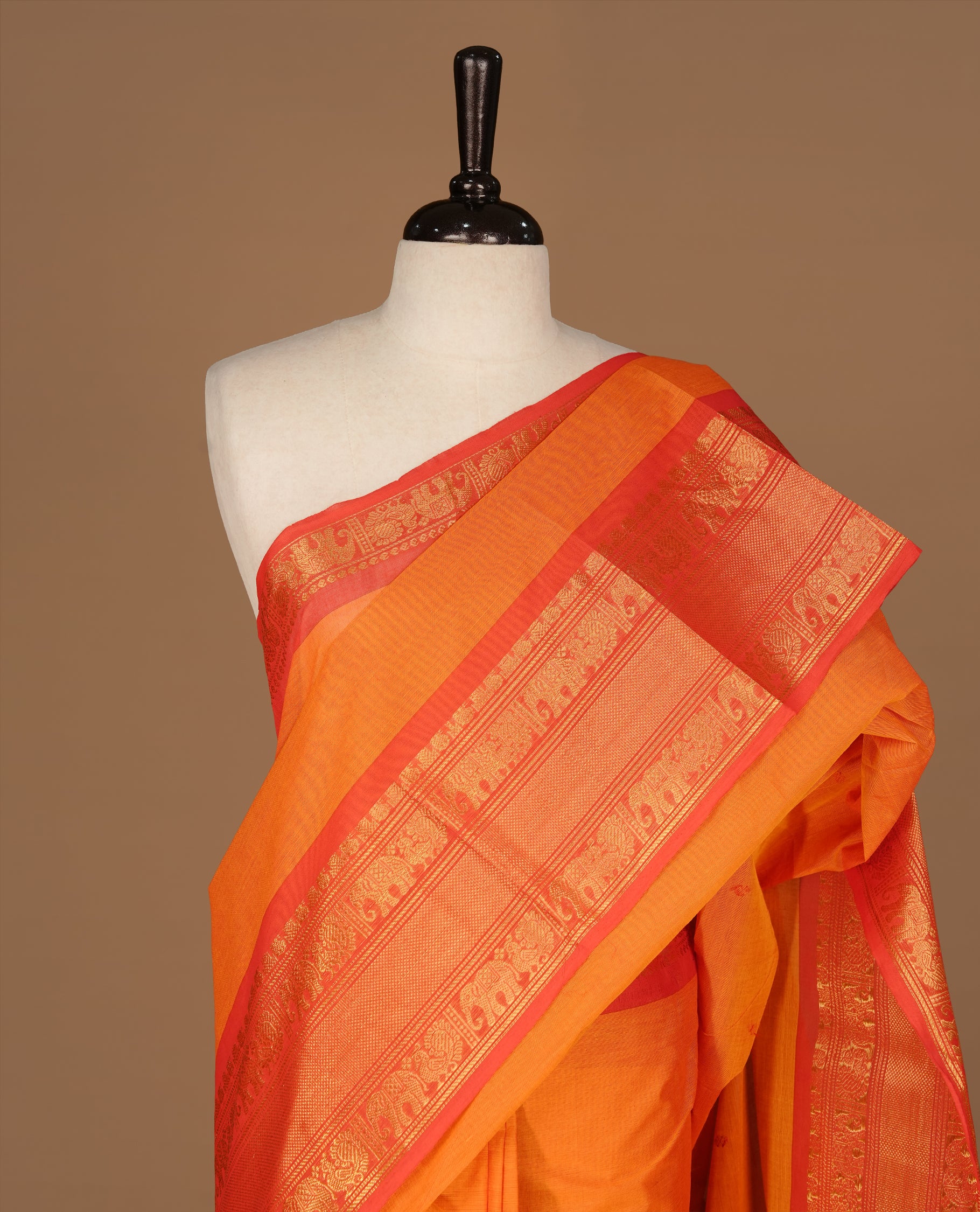 Orange Colour Chettinad cotton saree featuring Red motifs body , complemented by contrast Red colour with traditional border, comes with matching blouse piece.