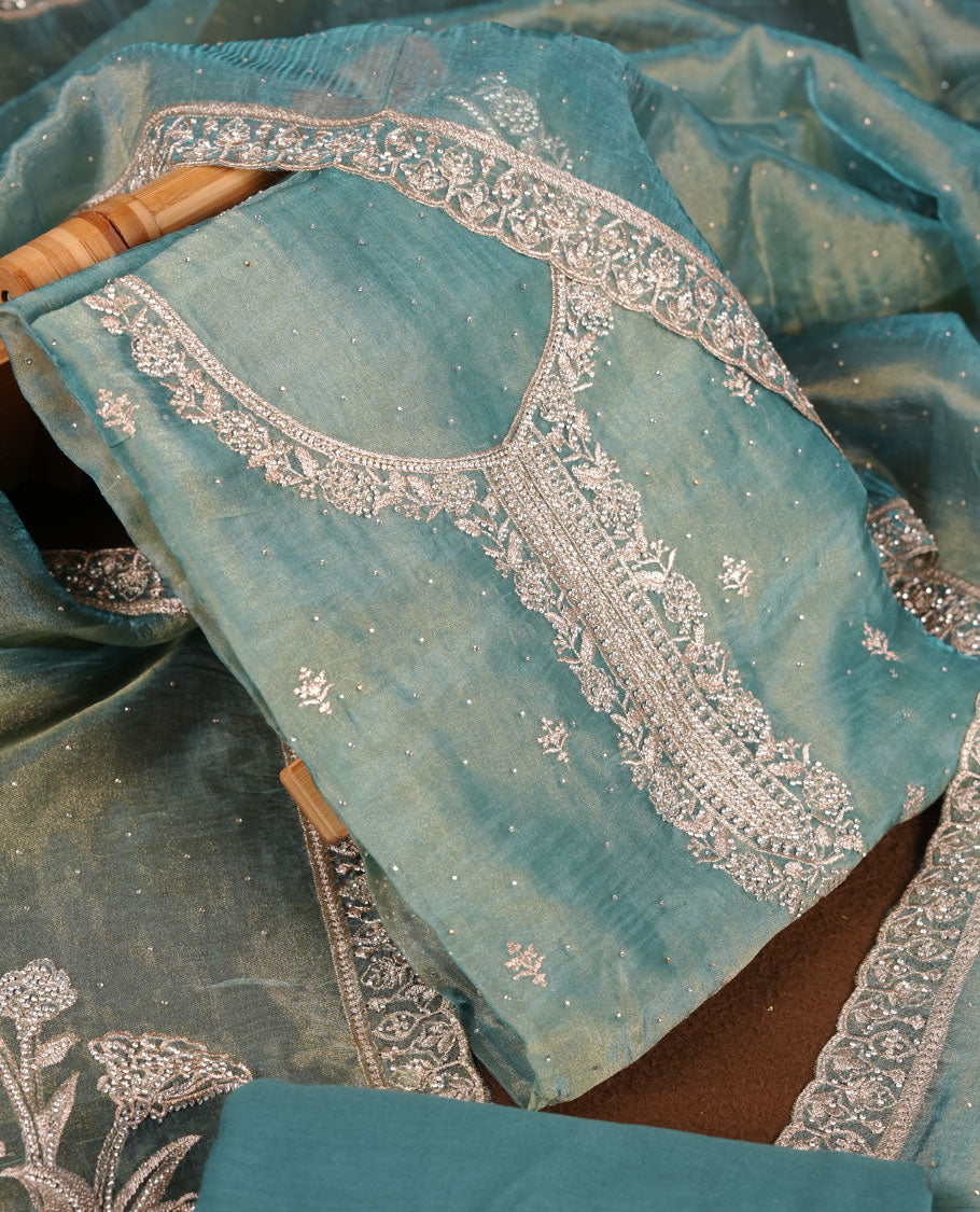 Powder blue colour churidar set with stone and thread embroidery and detailing, paired with matching pant and dupatta.