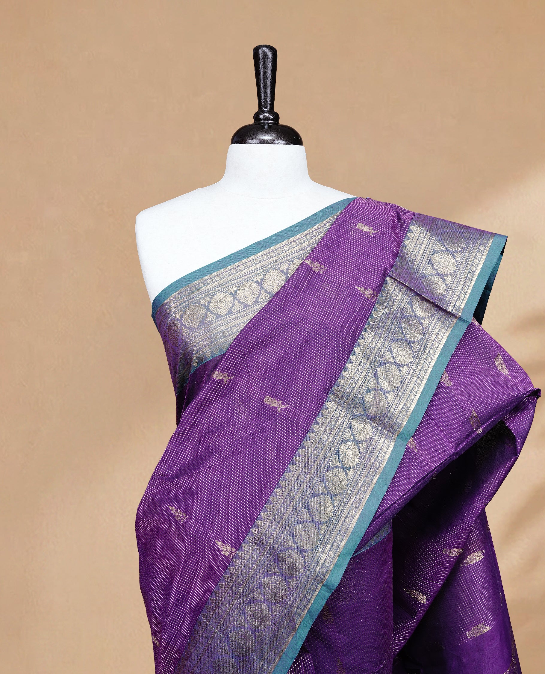 Purple colour chettinad cotton saree featuring gold zari stripes & motifs on body, complemented by Contrast Green colour with zari border, paired with matching blouse piece.