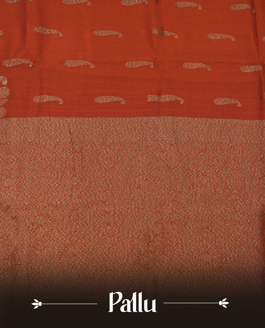 Burnt orange colour semi banaras tussar georgette featuring gold zari leaf pattern across body, finished with gold zari border and paired with matching blouse.