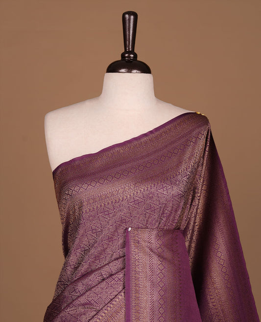 Purple colour semi banaras katan saree featuring Gold zari Pattern across body, complemented by self colour with zari border, paired with matching blouse piece.