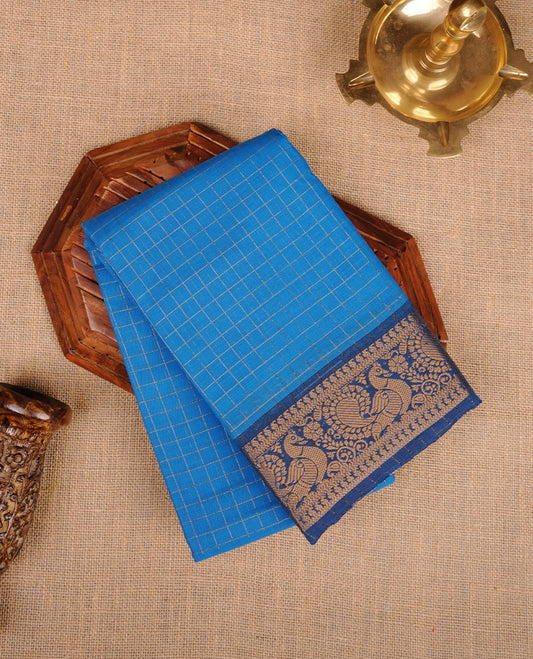 Blue colour chettinad cotton saree featuring gold zari check patterned body, paired with a dark blue colour traditional gold zari border without blouse.