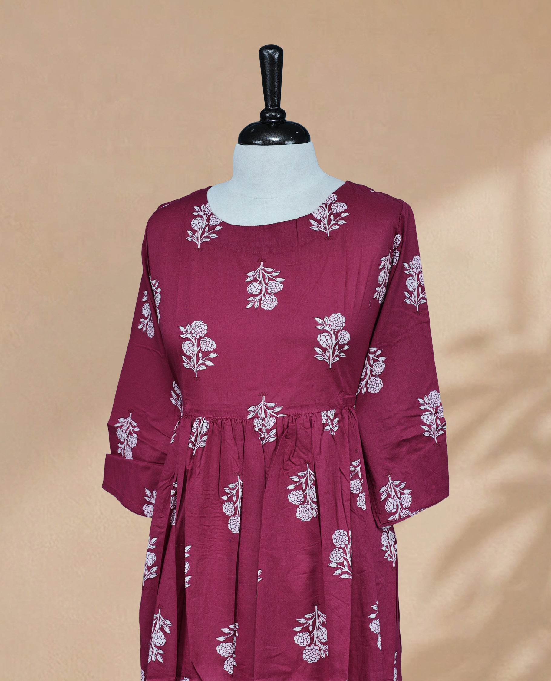 Magenta Green Kurti featuring white digital Floral prints across the body, a round neckline, and a 3/4-sleeve design.