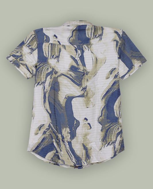 Off white colour shirt features a bold abstract print in blue and white tones, With short sleeves and a button-down front, its made from textured fabric, offering a stylish and modern look.