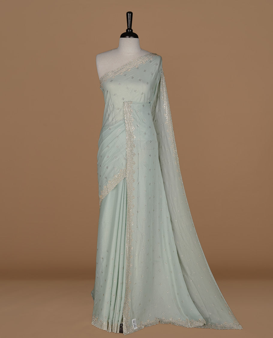 Mint colour organza designer saree featuring Gold stone motifs on body, highlighting light weight stone worked border, paired with matching blouse piece.