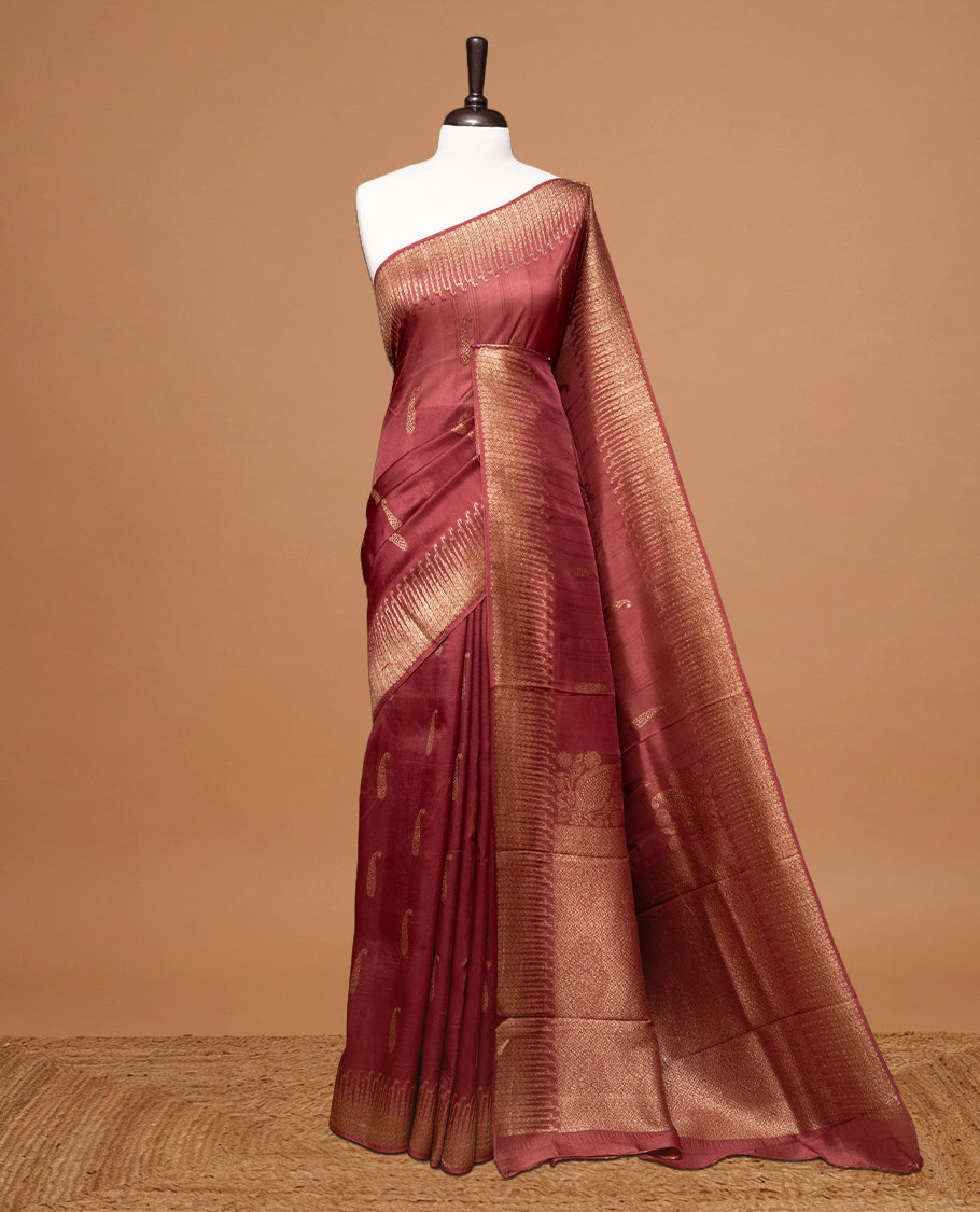 Burnt Umber colour Semi Banaras Tussar Georgette Featuring Gold zari Leaf pattern on body, Finished with Gold zari border and paired with matching blouse piece.
