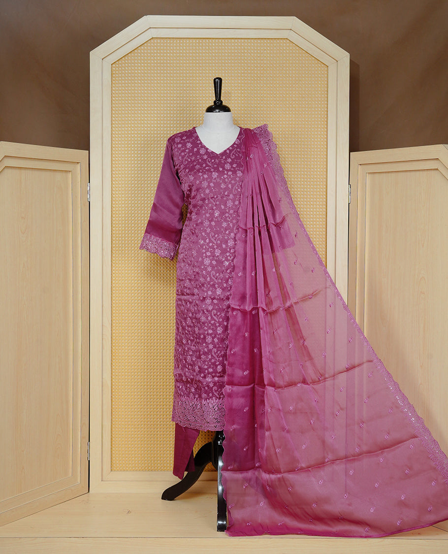 Dark Dusty Pink colour churidar set featuring delicate floral embroidery on the kurta, lace-trimmed sleeves and hem, paired with matching solid pants and an embellished sheer dupatta.