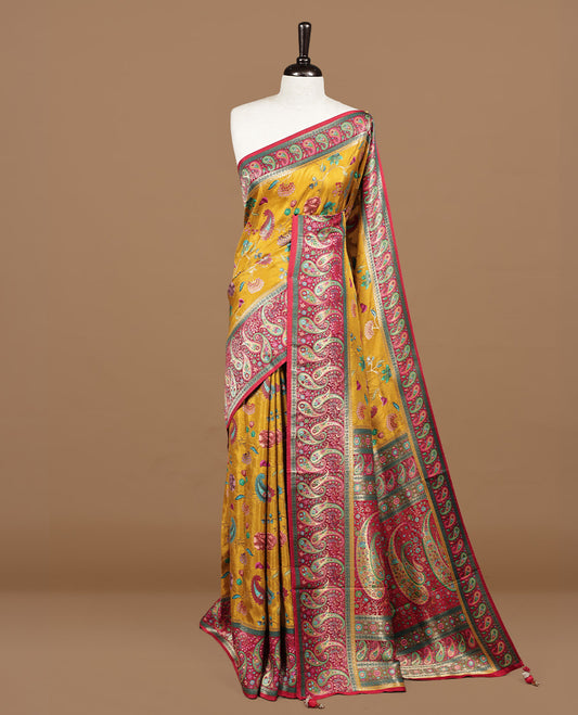 Mustard yellow colour Pashmina silk saree features an all over floral body, a contrast crimson red paisley border and pallu, and a matching unstitched blouse.