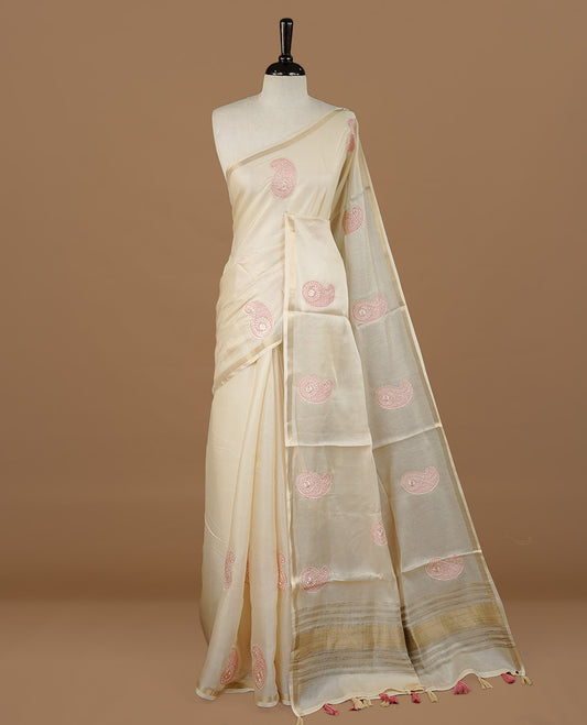 Cream colour Tussar saree featuring pink colour Mango pattern with chikankari embroidery work, highlighting gold zari simple border, paired with matching unstitched blouse.