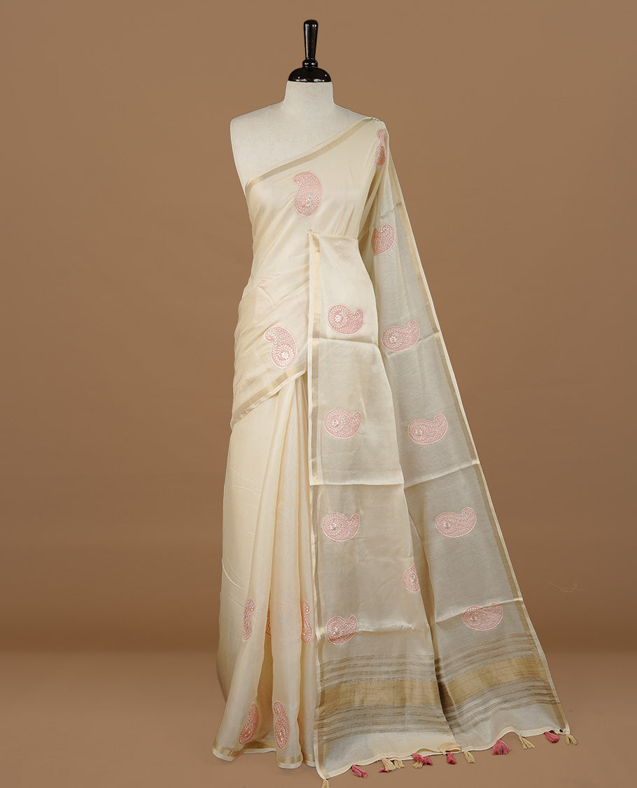 Cream colour Tussar saree featuring pink colour Mango pattern with chikankari embroidery work, highlighting gold zari simple border, paired with matching unstitched blouse.