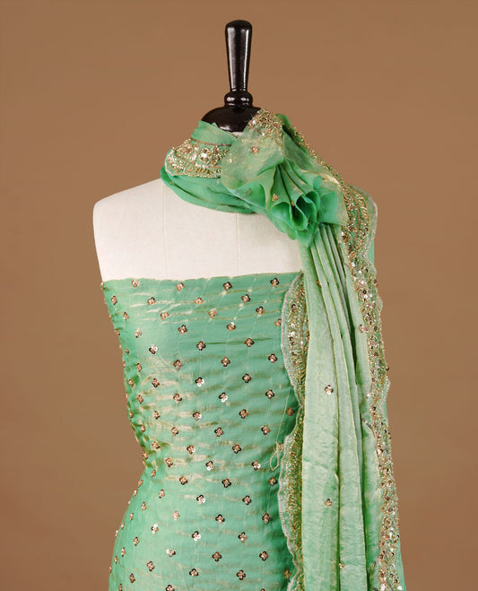 Mint green colour churidhar material featuring cut beads and sequins work on the body, paired with a matching unstitched bottom and worked dupatta.
