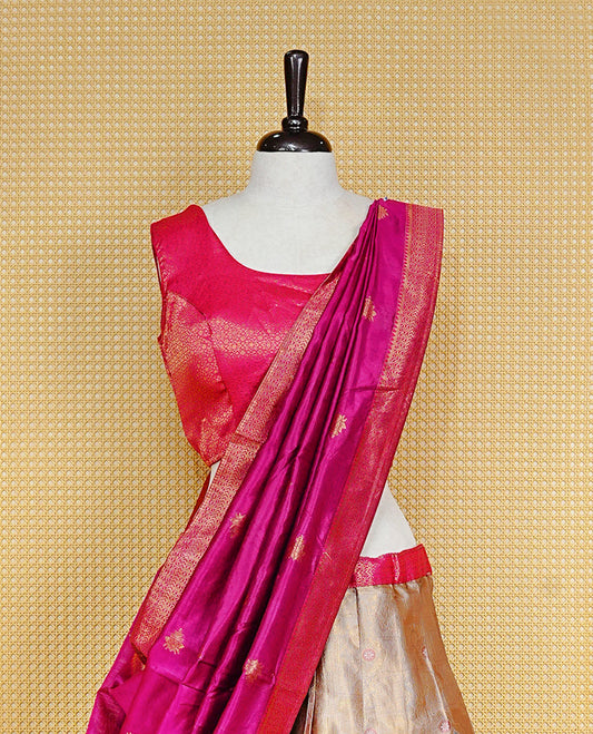 Cream colour Dhavni set Featuring cream Skirt with Gold zari Pattern and Contrast pink colour border, paired with Stitched Blouse & Elegant Dupatta.
