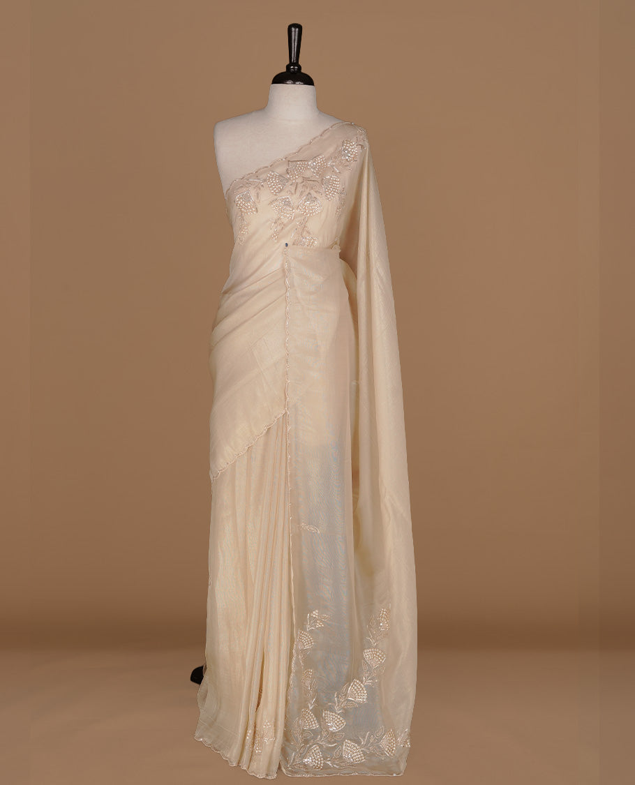 Beige colour net organza saree featuring thread, sequins, cut beats worked on body, highlighting scalp border, paired with matching blouse piece.