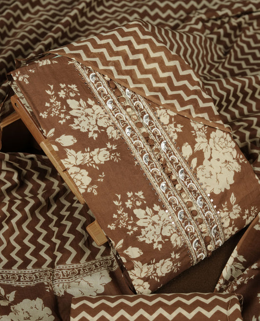 Brown colour churidar set with cream colour floral print, stone and thread embroidery and detailing, paired with matching pant and dupatta.