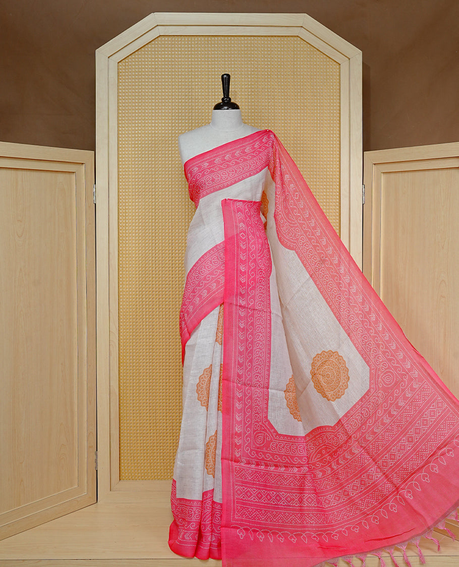 Cream colour semi linen saree featuring Mustard Ajrakh pattern print on body, complemented by contrast Light red colour with same pattern print border, comes with matching blouse piece.