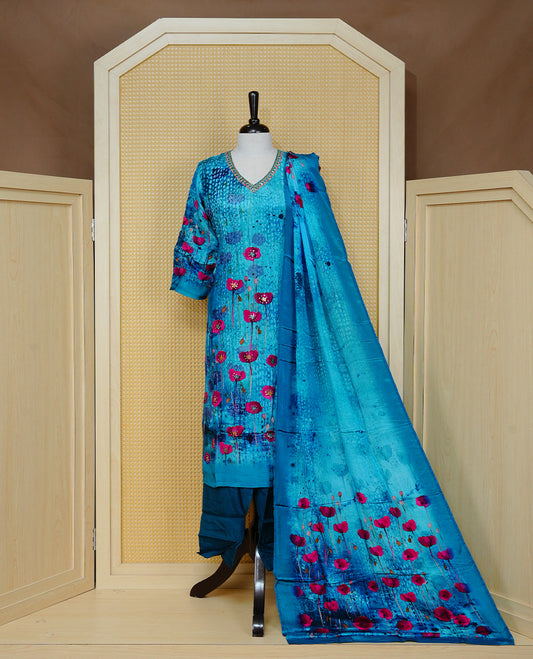 Blue colour churidar set featuring vibrant floral prints and delicate bead work on the V-neckline, paired with matching solid pants and a floral printed dupatta.