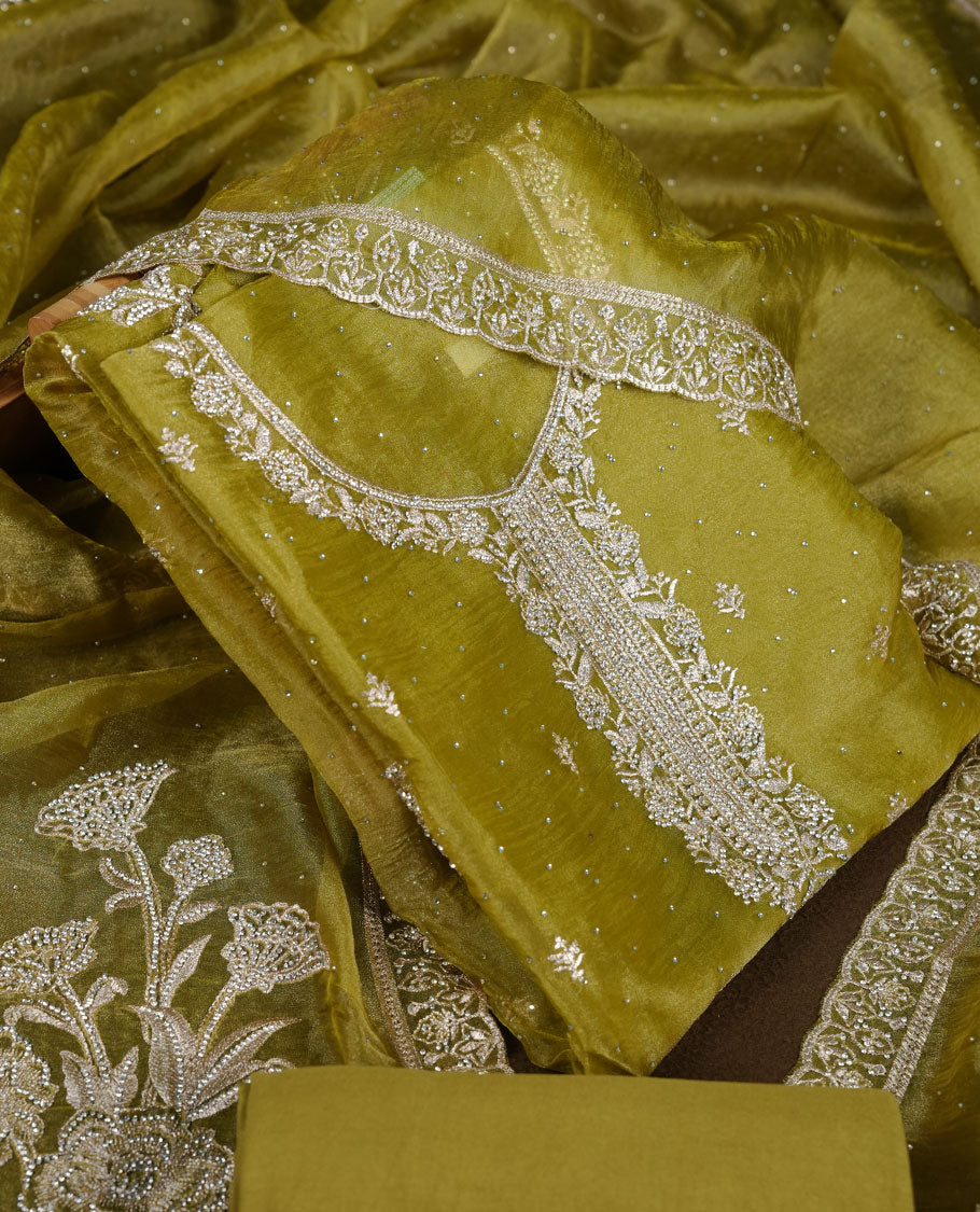 Olive green colour churidar set with stone and thread embroidery and detailing, paired with matching pant and dupatta.
