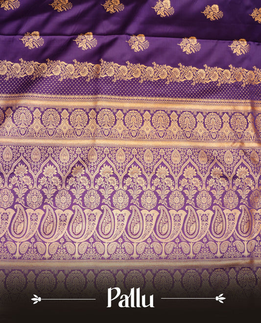 Indigo colour Banaras Satin Crepe saree featuring gold zari floral motifs on the body, a richly woven traditional border with intricate gold zari detailing, and paired with a matching blouse.