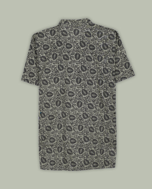 Beige colour short sleeve shirt with black floral and paisley print, featuring a classic chinese collar and wooden button half placket, A breezy and stylish pick for both relaxed days and casual evenings.