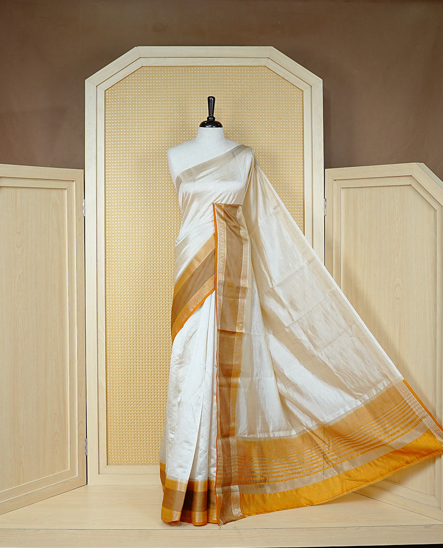 Cream colour semi Tussar silk saree featuring  Elegant body, Complemented by contrast Mustard with rich zari detailed for onam special, paired with contrast Blouse for Festive look.