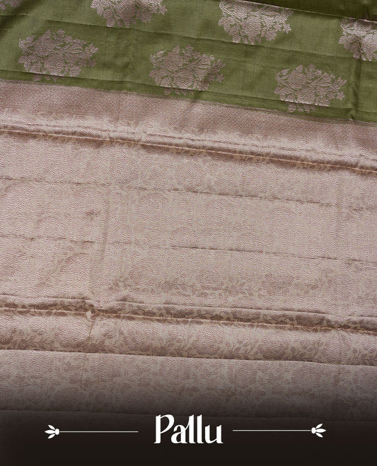 Olive green colour pure banaras tusser silk saree highlighting antique zari pattern across body, with contrast cream colour with zari border and paired with matching blouse