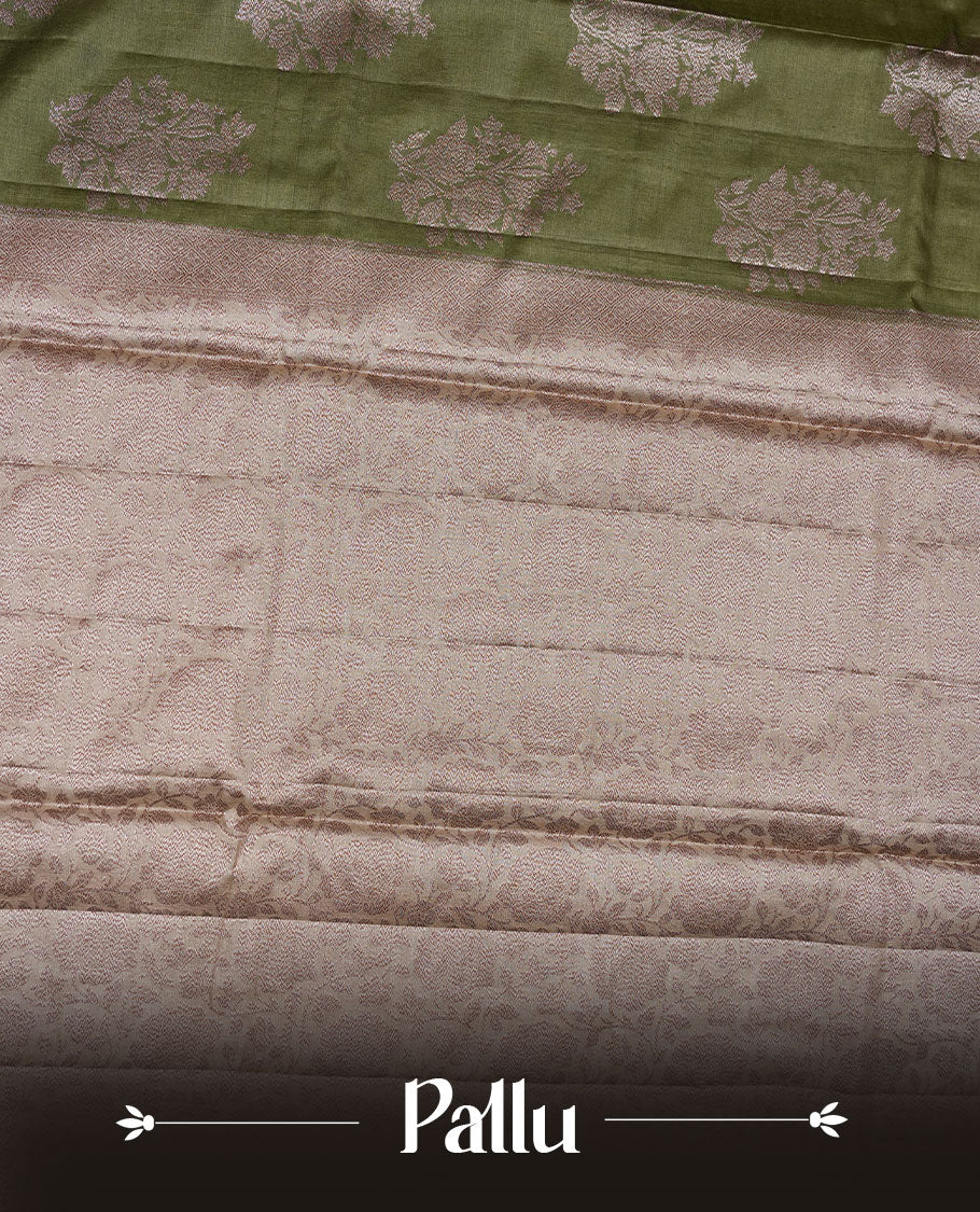 Olive green colour pure banaras tusser silk saree highlighting antique zari pattern across body, with contrast cream colour with zari border and paired with matching blouse