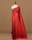 Red colour kalyani cotton saree featuring check pattern on body, highlighting self colour with simple gold zari border, paired with matching blouse piece.