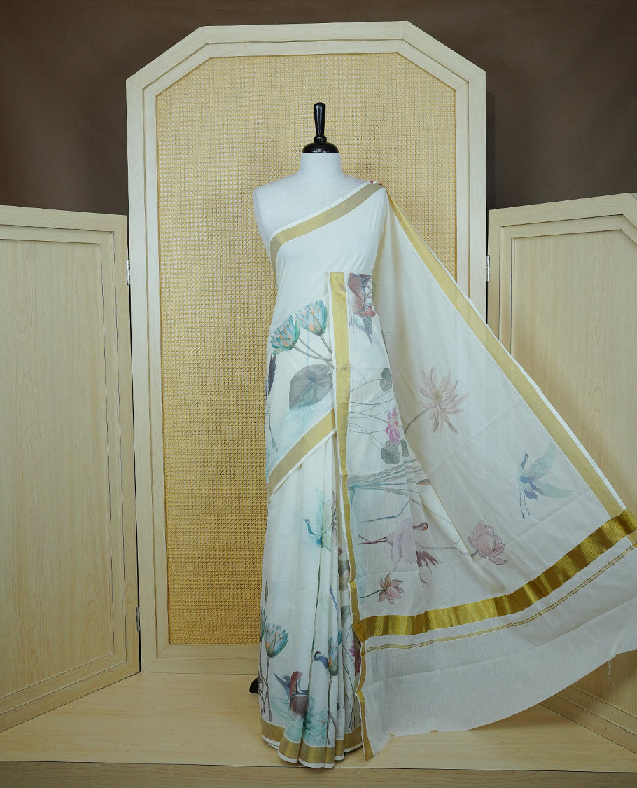 Cream colour Cotton kerala Saree featuring Flower & Bird Print on body, Enhancing Gold zari kasavu border, comes with matching blouse piece.