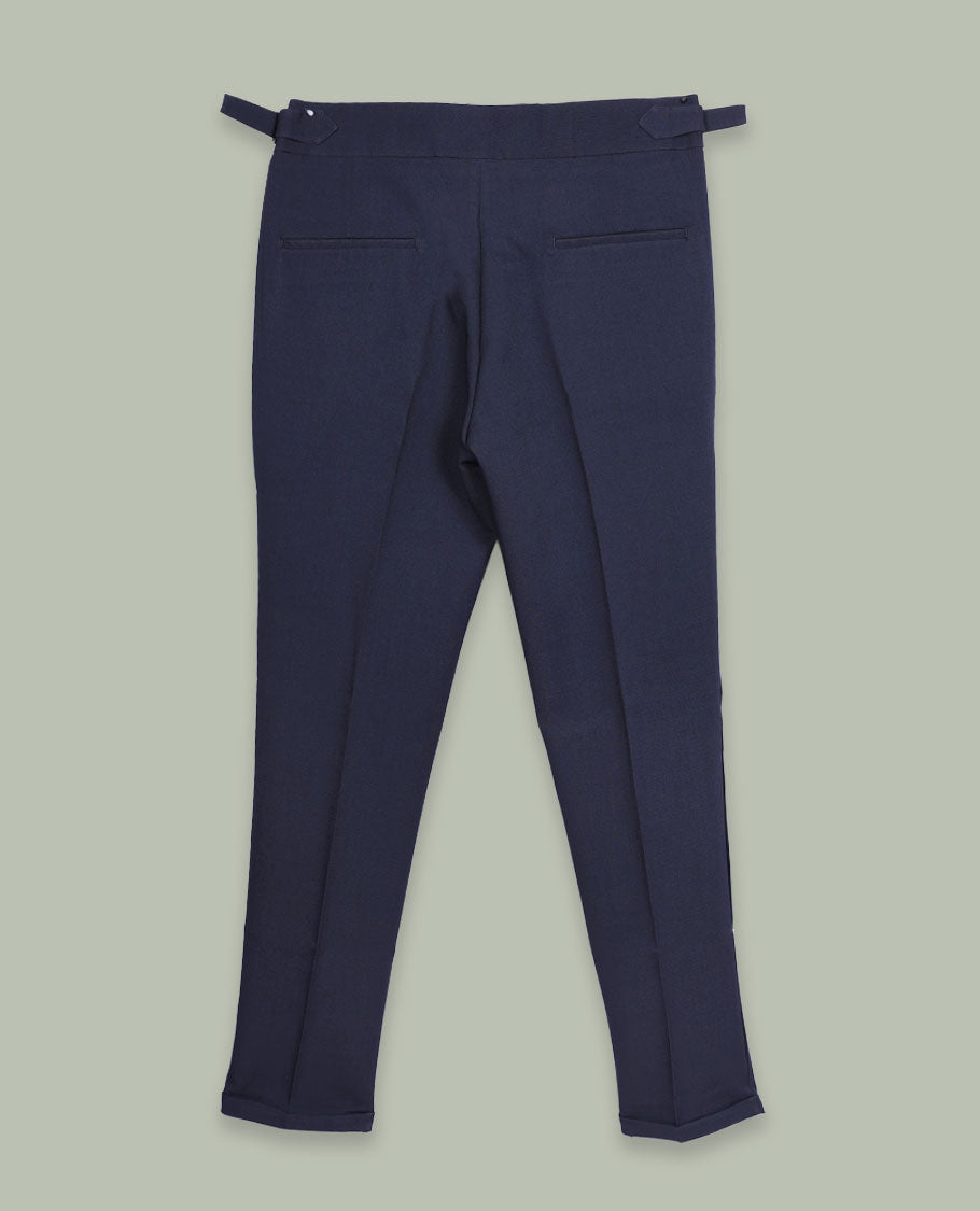 Navy blue colour men’s pant featuring a clean waistband with side buckle adjusters, neat front pleats, slant pockets and back welt pockets, finished with a straight leg fit.