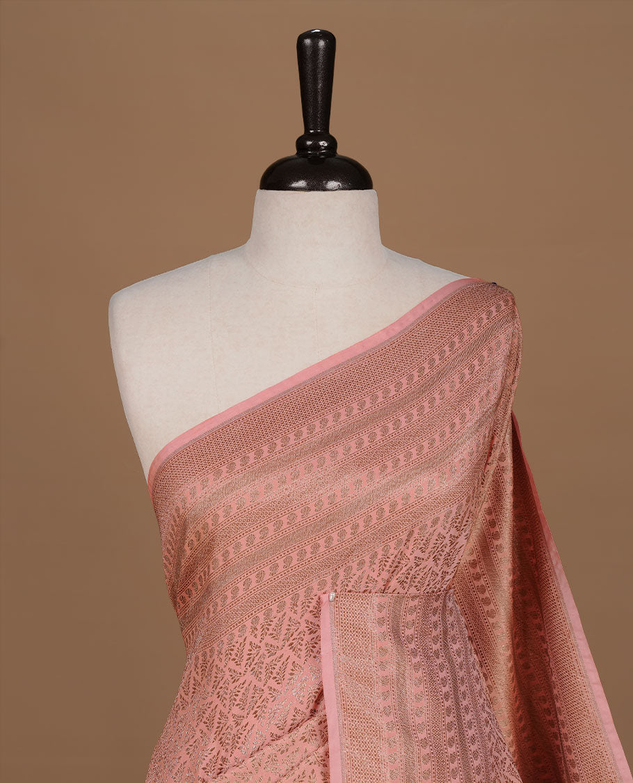 Peach colour Semi Banaras Katan saree featuring Antique zari Floral pattern on body, complemented by self colour zari border, paired with matching blouse piece.