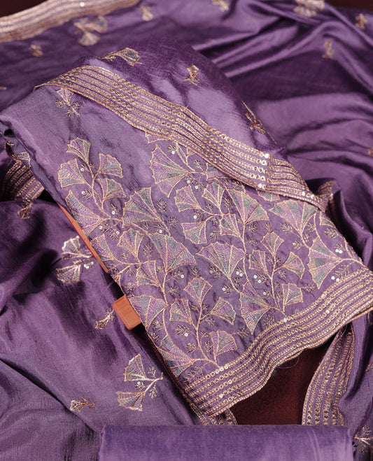 Lavender colour olive colour churidar material with subtle mirror and thread embroidery, finished with delicate border detailing and paired with a matching plain bottom and dupatta.