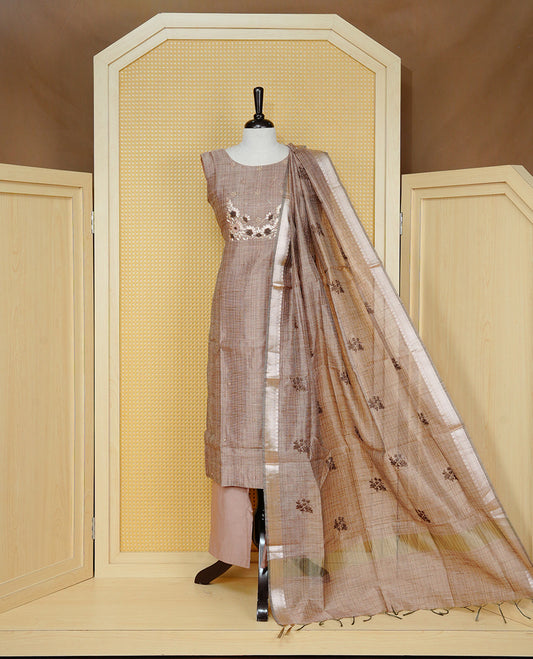 Brown colour Tissue Churidar Set featuring delicate floral embroidery and subtle bead detailing on the yoke, paired with matching solid pants and dupatta.