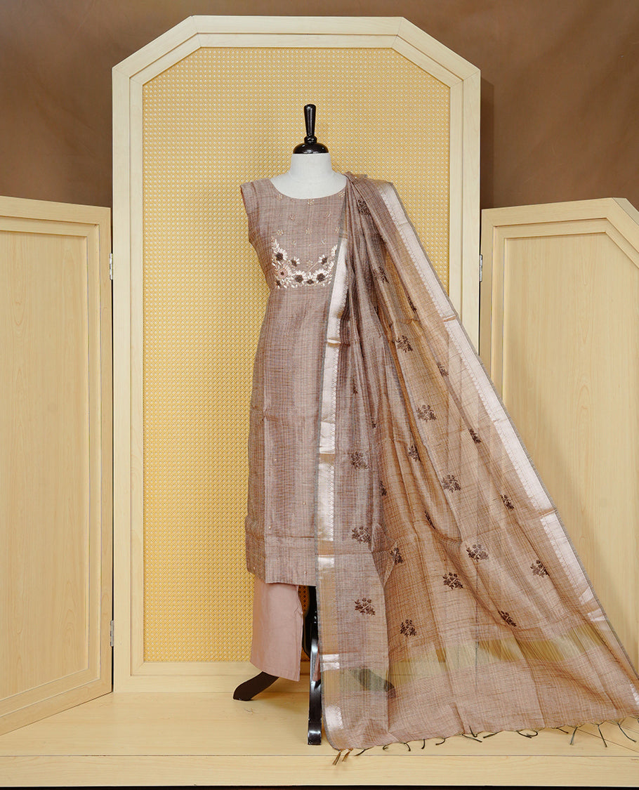 Brown colour Tissue Churidar Set featuring delicate floral embroidery and subtle bead detailing on the yoke, paired with matching solid pants and dupatta.