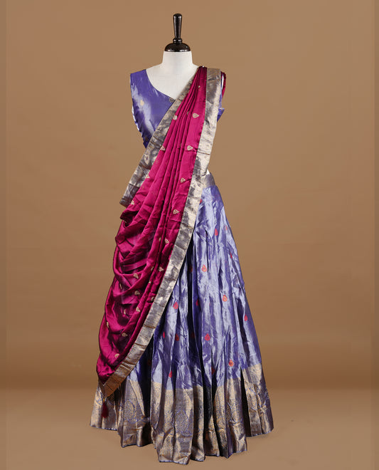 Lavender colour featuring lavender colour skirt highlighting gold zari motifs & border, contrast maroon dupatta, with matching stitched blouse.