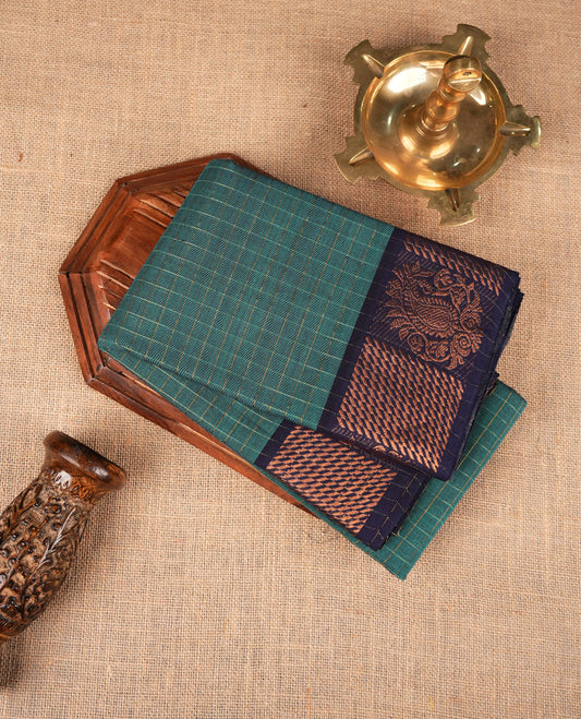 Teal colour sungudi cotton saree featuring gold zari check pattern across body, contrast Dark blue colour with gold zari pattern on border, without blouse piece.