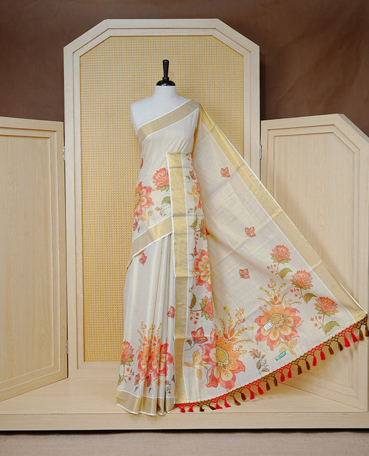 Cream Colour Tissue Kerala  Saree Featuring A Digital Floral Printed Body &  Pallu, , Beautifully Enhanced With A Classic Gold Zari Border And Red & Olive Green  Tassels, Paired With A Matching Blouse Piece.