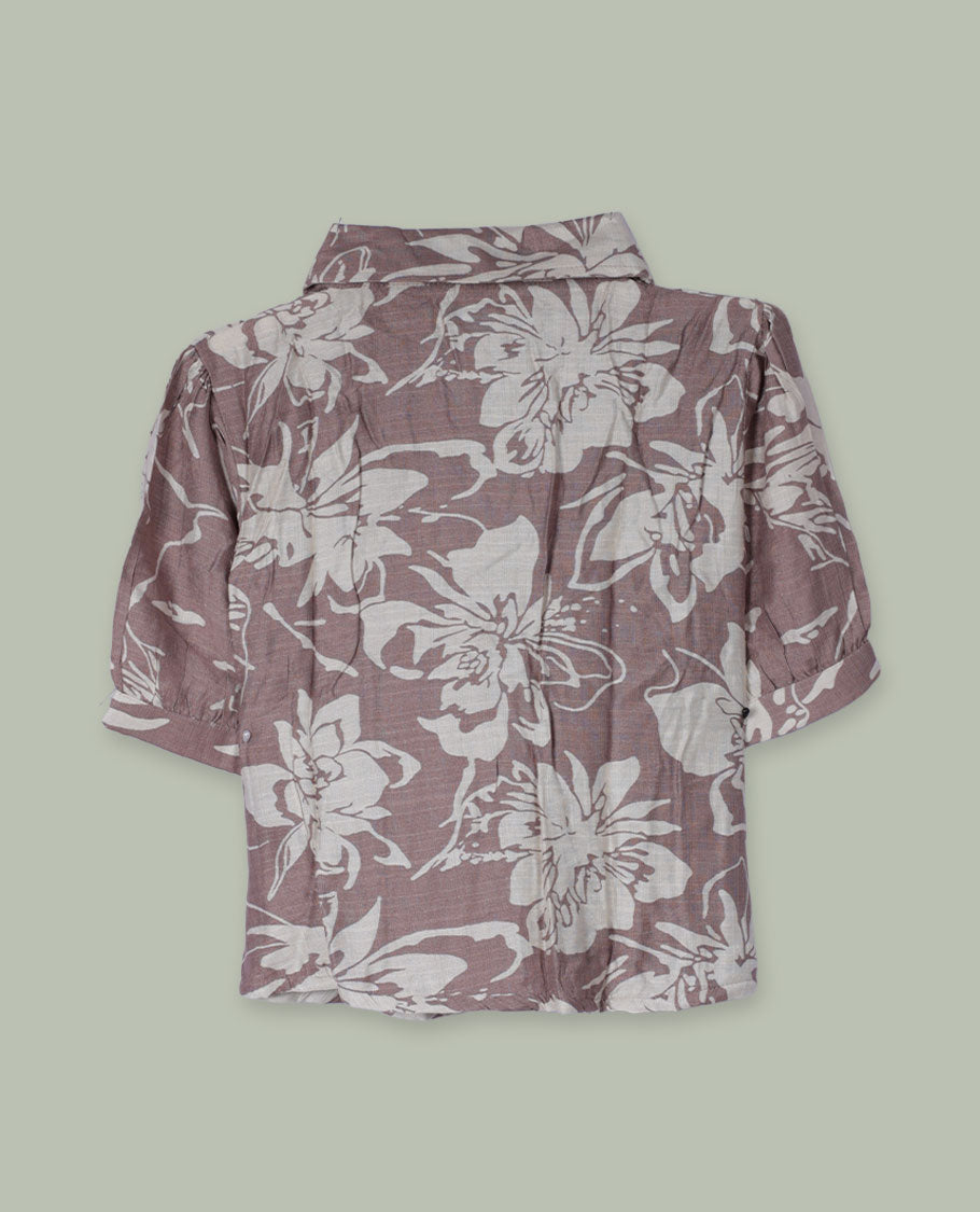 Dusty mauve floral printed shirt top with collared neckline, front button placket, short cuffed sleeves, and soft gathers at the shoulders.