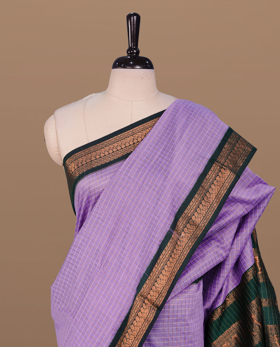 Lavender colour kalyani cotton saree featuring gold zari check pattern on body, complemented by green colour with Antique zari border, paired with matching blouse piece.
