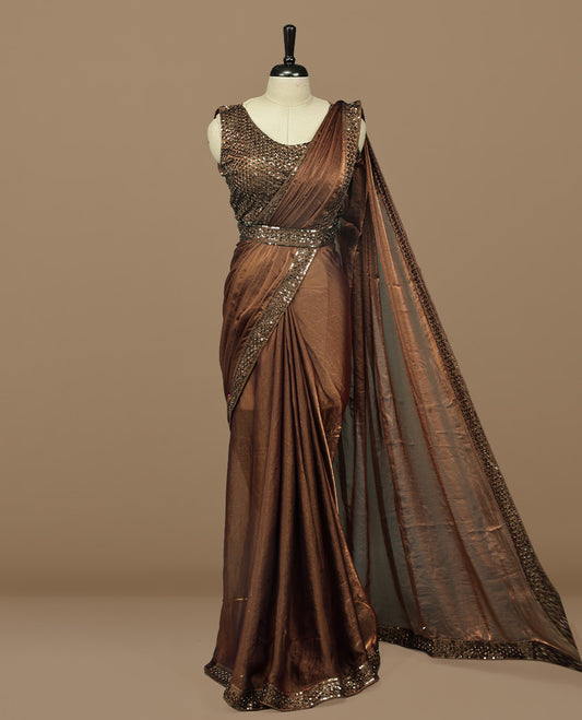 Gold & brown double shade designer saree features Elegant plain body, highlights Sequins & cut beats on border, paired with ready made blouse.